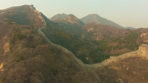 Great Wall of China at Sunset and Mountains. Badaling. Aerial View. Reveal Shot. Drone Flies Backwards and Upwards