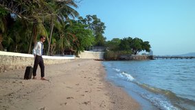happy businessman in a suit and dark glasses is splashing in the sea at luxury resorts. concept of long awaited vacation, freelancing - Powered by Shutterstock - Get 15% off with code: PIKWIZARD15
