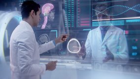 Two doctors having an online video conference analyze a patient's medical MRI diagnosis by checking on a large glass screen with futuristic holograms. Concept of: medicine, doctors, future, holography - Powered by Shutterstock - Get 15% off with code: PIKWIZARD15