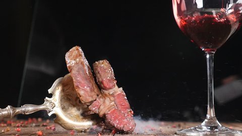 Closeup shot of Liquid nitrogen and delicious steak on vintage fork. Bartender pouring red wine in wine glass in slow motion. Restaurant dishes serving. Open kitchen concept. hd