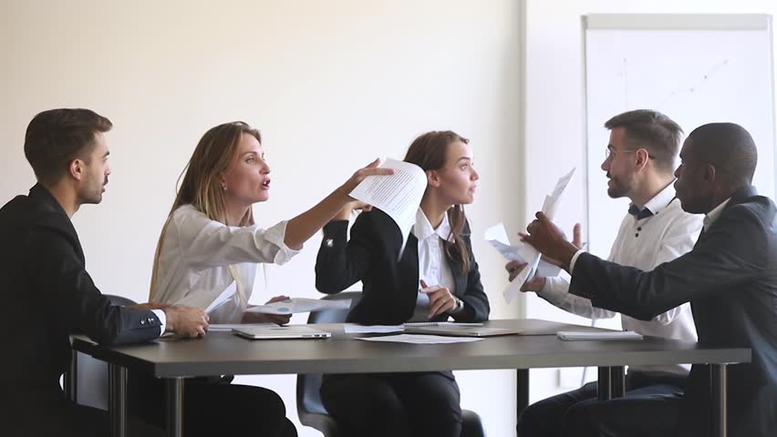 Angry diverse team colleagues argue over paperwork shouting during company business group meeting, mad annoyed coworkers disputing about documents quarreling shouting dissatisfied with bad teamwork | Shutterstock HD Video #1028009552