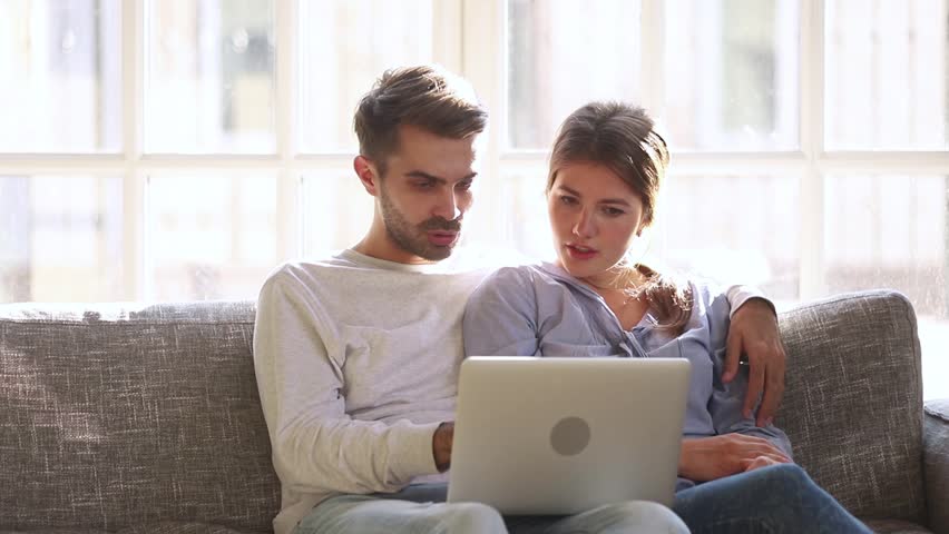 Excited happy young family couple looking at laptop computer feel winners surprised by lottery betting winning bid, celebrate good internet news embracing overjoyed by victory achievement online Royalty-Free Stock Footage #1028009567