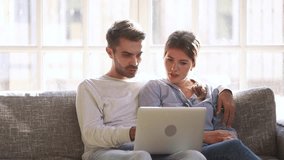 Excited happy young family couple looking at laptop computer feel winners surprised by lottery betting winning bid, celebrate good internet news embracing overjoyed by victory achievement online