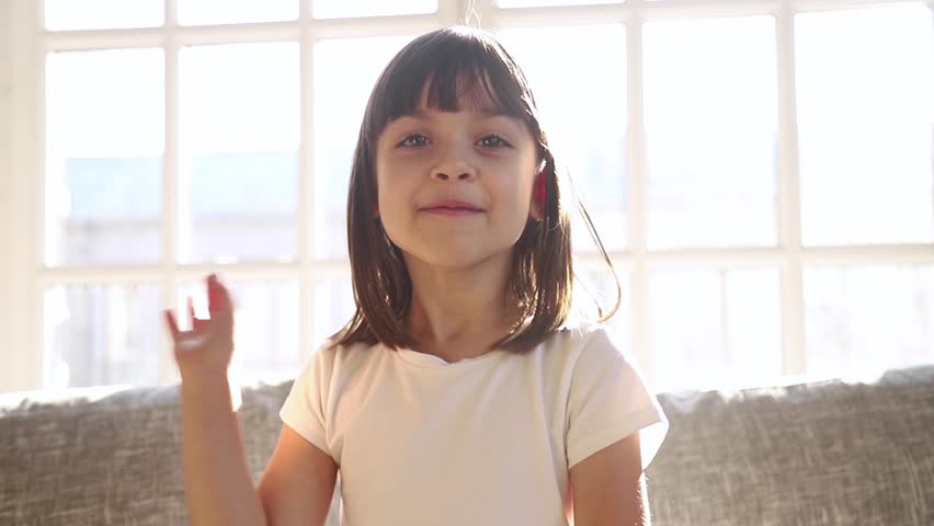 Cute small girl blogger talking to camera recording vlog at home, happy little vlogger waving hand looking at webcam kid child make video call on communicate online sit on sofa at home Royalty-Free Stock Footage #1028009576