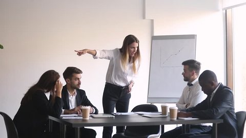 Male worker get scolded fired by angry female boss leaving office team meeting and quit, mean business woman manager firing shouting at stressed man employee dismiss incompetent intern in boardroom
