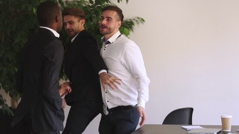 Businessman disagrees with a colleague and throws papers at a business meeting, Mad coworkers having conflict confrontation at work in an office