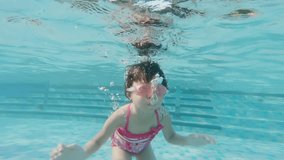 cute girl swim in the swimming pool