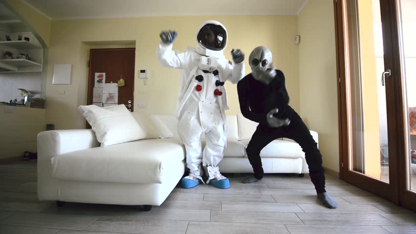 Crazy dance with an astronaut and a grey alien. Cosmonaut and creature from space making party | Shutterstock HD Video #1028015567