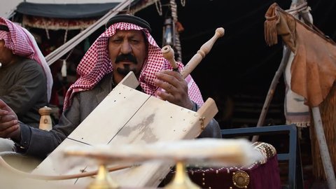 Riyadh, Saudi Arabia – January 5th 2019: Arabic man from Saudi Arabia perform traditional song and music on traditional instrument called Rababah