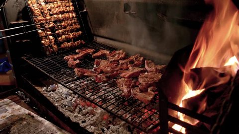South African barbecue of lamb chops and skewers over an open wood fire with coals