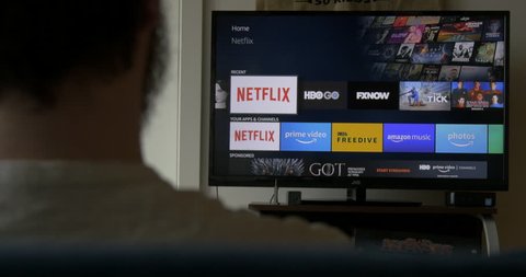 Man Browses through Netflix Shows at Home