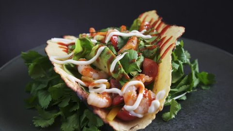 Freshly Prepared Shrimp Taco rotating on black background, 4k. Restaurant, Street Food quality