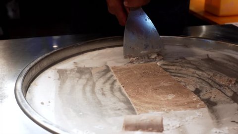 Unidentified chef is making delicious chocolate ice cream rolls at in Siem Reap, Cambodia Stock Video
