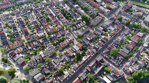 Aerial footage of typical Dutch neighborhood showing the buildings and rooftops with the characteristically architecture located in the north part of the Netherlands 4k high resolution material