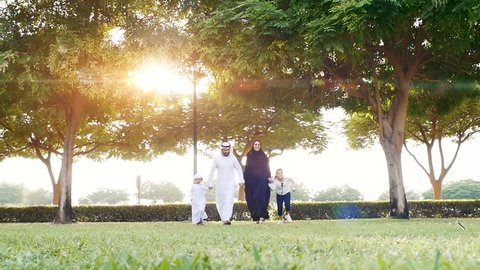 Happy family in Dubai . Artistic digital sun flare in the background