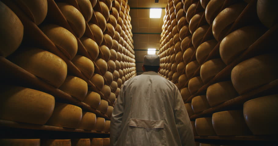 Slow motion close up of a cheesemaker is controlling the seasoning of Parmesan cheese, which was maturing by ancient Italian tradition for many months. Royalty-Free Stock Footage #1028069069