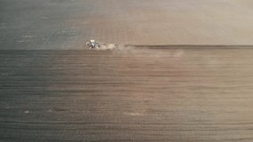Tractor processes field. Aerial Footage