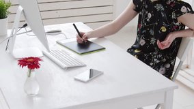 Concept of freelancing or office work. Young female photographer, retoucher or graphic designer with colored hair works at a computer and smokes vape - Powered by Shutterstock - Get 15% off with code: PIKWIZARD15