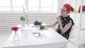 Concept of freelancing or office work. Young female photographer, retoucher or graphic designer with colored hair works at a computer and smokes vape - Powered by Shutterstock - Get 15% off with code: PIKWIZARD15