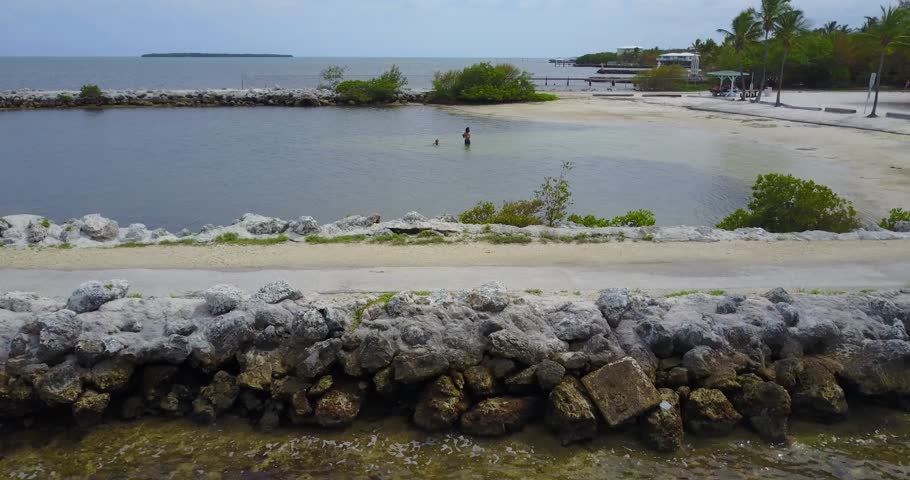 AERIAL: very fast portrait slide across a rocky path that