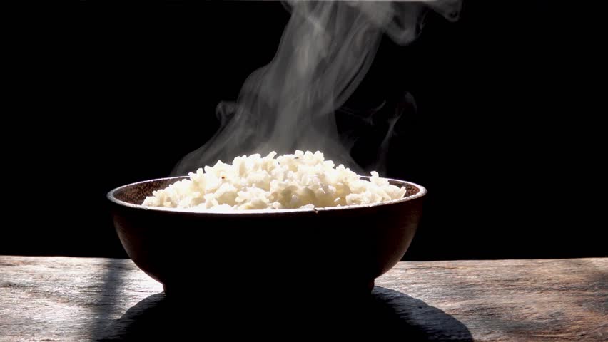 Cooked rice with steam in wooden bowl on dark background,hot cooked rice in bowl selective focus,soft focus Royalty-Free Stock Footage #1028083796