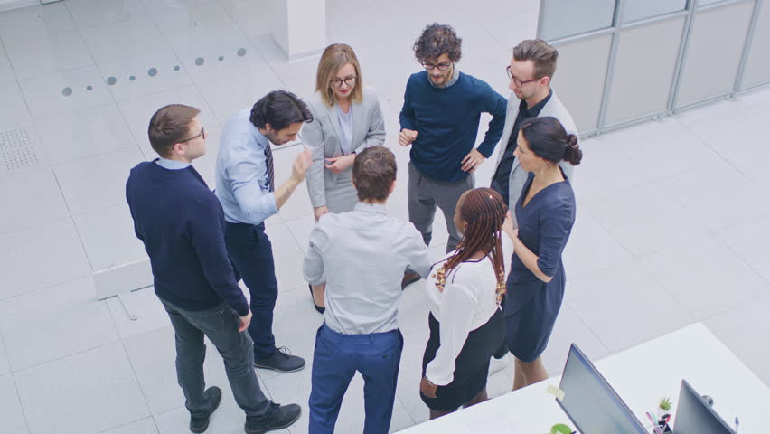 Office Workers doing Team Building Exercise Stacking Hands Together in the Unifying Spirit of Creativity and Common Cause. Eight Successful People Applauding Together. High Angle Shot in Modern Office Royalty-Free Stock Footage #1028085821