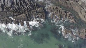 Sea waves breaking in the reefs of the coast in Sonabia #074, Spain, Cantabrian sea - drone aerial 4k footage ungraded (graded version available)
