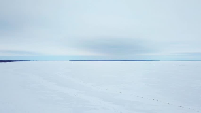 AERIAL: 4K drone aerial of frozen Lake Winnipeg in Manitoba, Canada and a large pressure ridge running along the south basin. Ice ridge is near Hecla, Gull Island, and Riverton.