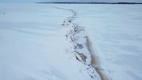 AERIAL: 4K drone aerial of frozen Lake Winnipeg in Manitoba, Canada and a large pressure ridge running along the south basin. Ice ridge is near Hecla, Gull Island, and Riverton.