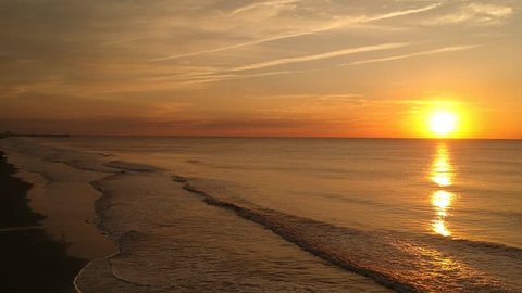 Drone shot of the Sunrise as the waves break in the Atlantic Ocean.