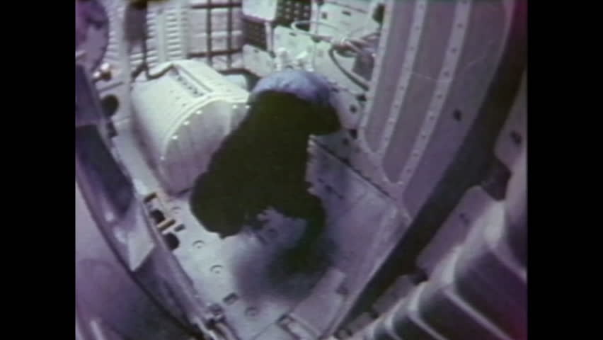 1980s: Astronaut floating in zero gravity inside space shuttle, floats up ladder to upper level. Looking out window of space shuttle at space. | Shutterstock HD Video #1028101952
