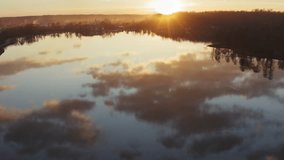 Aerial Drone Flight Footage above calm water in sunset. Incredible reflections, 4k