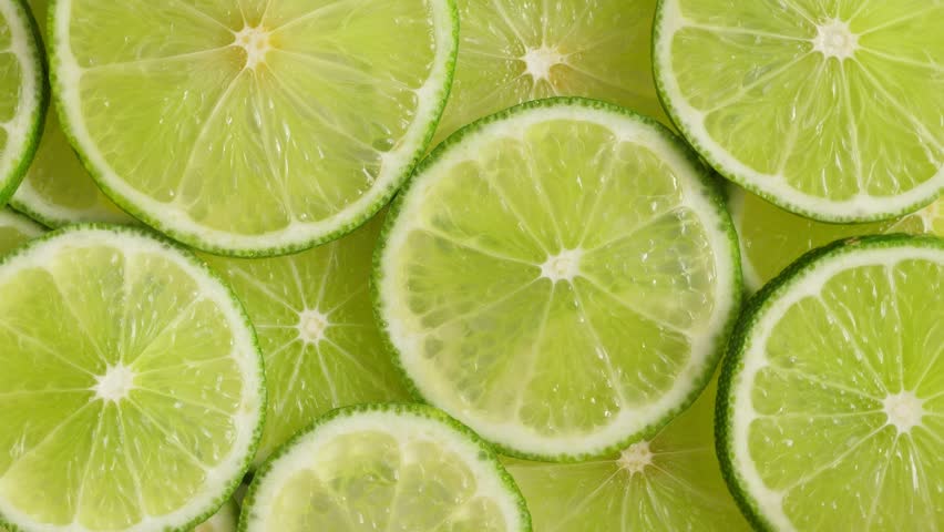 Lime slices closeup, macro food summer background, fruits top view. Rotate Royalty-Free Stock Footage #1028123000