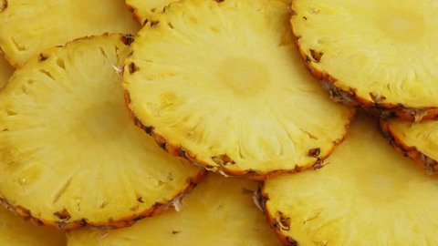 Sliced pieces of delicious pineapple fruit. Tropical summer food concept. Rotate