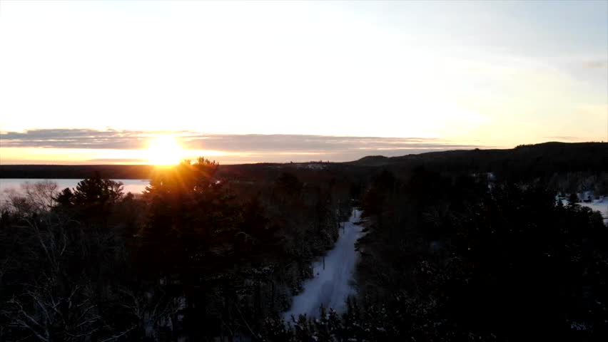 Snow Covered Lake Winter Northern Michigan Copper Harbor Sunset in the Forest.