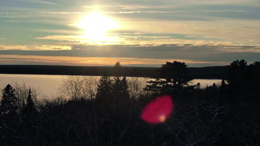 Snow Covered Trees in Northern Michigan Copper Harbor Sun-flare Sunrise.