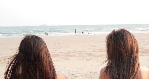 Rear view beautiful asian young girls beach sand off ass slow motion wearing string bikini sexy butt tropical vacation travel holidays. 4K resolution and slow motion.