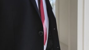 Businessman, groom, Young business man buttoning a business suit. close-up