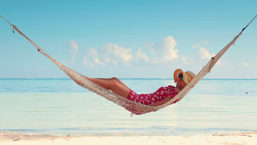 Girl relaxing in a hammock on tropical island beach. Summer vacation in Punta Cana, Dominican Republic Royalty-Free Stock Footage #1028131940
