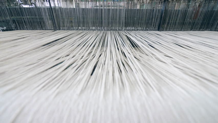 A loom weaving threads, working automatically at a factory. | Shutterstock HD Video #1028132795