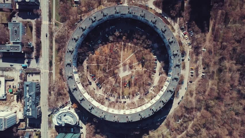 Aerial view of a 9-storey residential building in the form of a ring built in the late 1970s.
