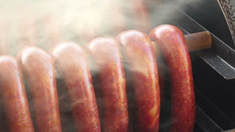Close up pan shot of homemade smoked sausage during smoking process.