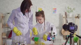 woman and teenage girl blogger,mix the reagents in a chemical laboratory