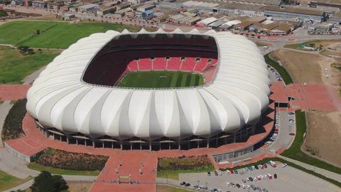 Port Elizabeth, South Africa - circa 2010s: Close clockwise aerial orbit of Nelson Mandela Bay Stadium. See entire roof structure and surrounding paved area, alongside North End Lake and parks