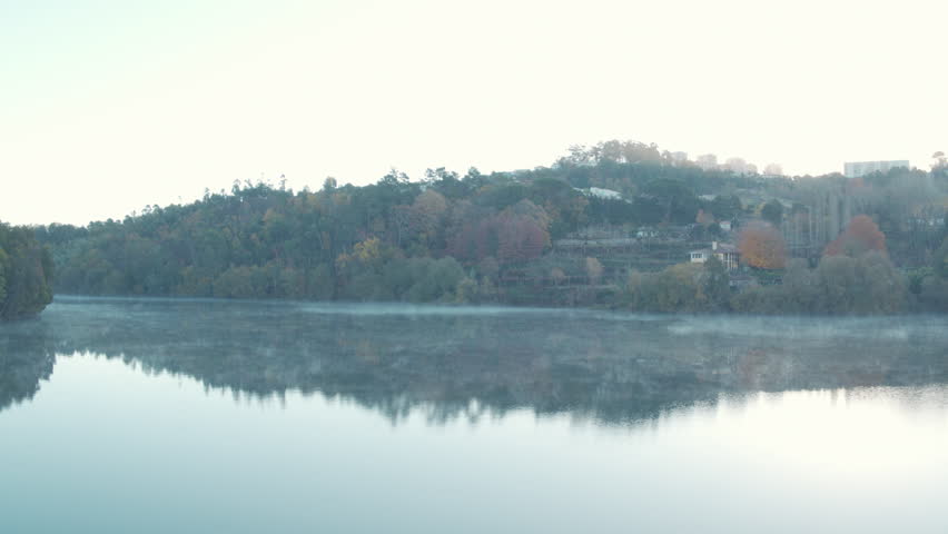 A pan aerial shot in 4k of the Douro River on a foggy morning.
