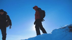 man traveler hiking in winter mountains silhouette sunlight slow motion video. travel adventure the winter lifestyle snow concept