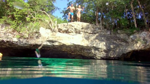 Puerto Morelos, Q.R. / Mexico - January 6, 2016: Couple Jumping Into a Cenotes in Tulum