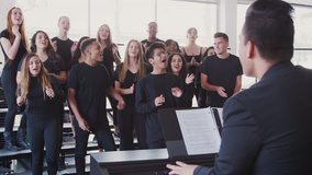 Male And Female Students Singing In Choir With Teacher At Performing Arts School - Powered by Shutterstock - Get 15% off with code: PIKWIZARD15