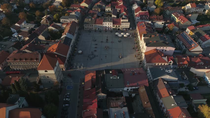 The main square of a small old Polish town of Zywiec, Silesia, seen from a drone at an autumn golden hour.
You can seen the square, shades, cafes, restaurants, fountains and tourists.
