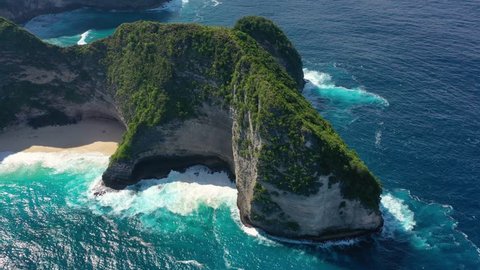 Aerial view at sea and rocks. Turquoise water background from top view. Summer seascape from air. Kelingking beach, Nusa Penida, Bali, Indonesia. 